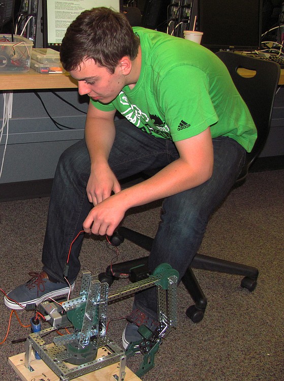 CHS junior Parker Liebe works out glitches with his state Science Olympiad project for the "robot arm" event. "As a Science Olympiad coach, Mr. Wright is pretty amazing," he said. "I can't even begin to describe how smart he is, and how much he brings to this group."
