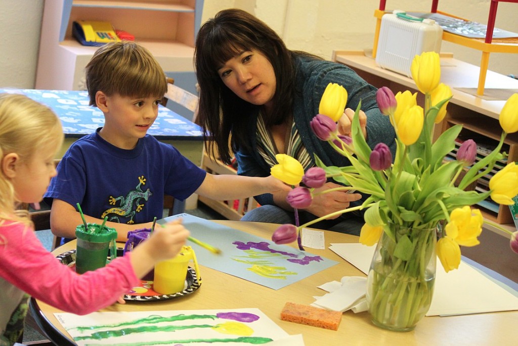 Parent Tina Nelson works with students Ainzlee Hardy (left) and Rafael Lavagnino. According to Lattanzi, parent involvement is an integral part of the curriculum at the C-W Co-op. "Moms, dads and other family members work with the children," she said. "I have more freedom because there is a parent in the classroom. It's a wonderful thing."