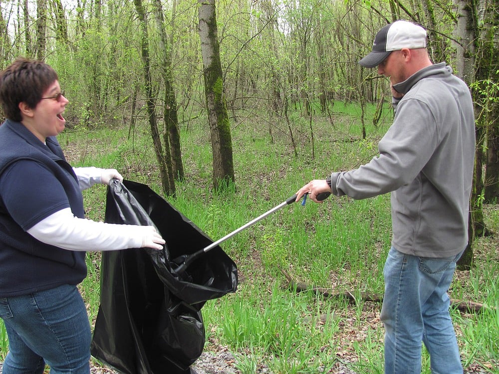 Debra Itzen and Jeramy Wilcox, Port of Camas-Washougal employees, participate in the Earth Day cleanup at Capt. William Clark Park in Washougal Friday.