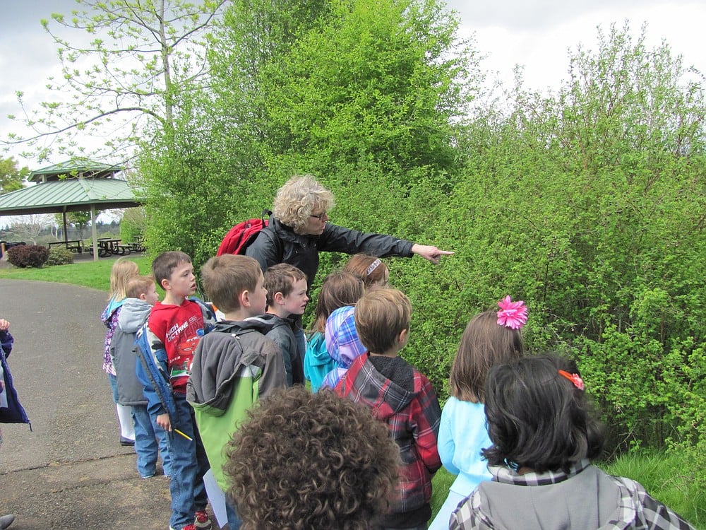 Grass Valley Elementary first-grade teacher Jennifer Sanchez points out a bird to her students during a nature walk on Earth Day. The students wrote down their observations of different insects, plants and animals seen during the walk.