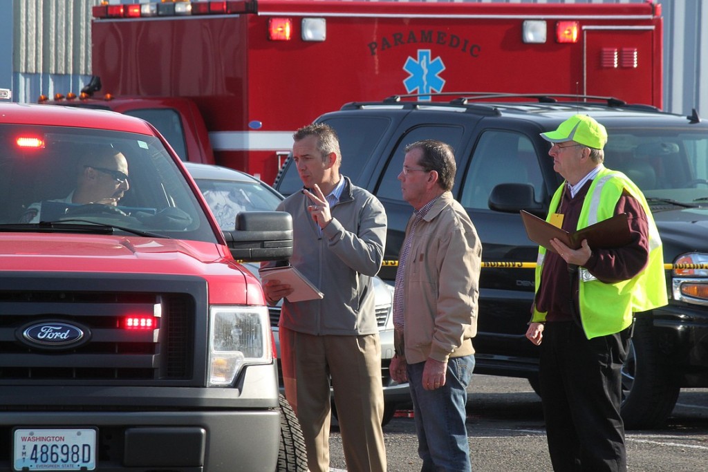 Port Executive Director David Ripp and Project Manager Larry Connolly talk to emergency personnel from the Camas-Washougal Fire Department during the drill. Consultant Don MacLardy of Emergency Safety Solutions looks on.