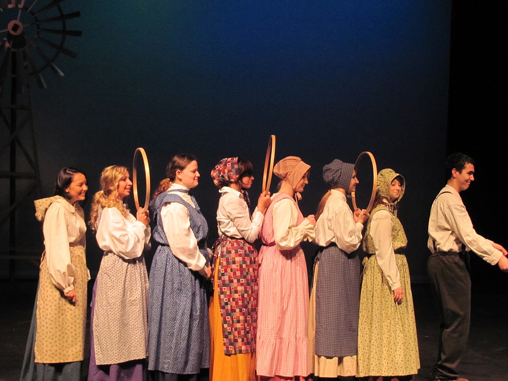 Cast members tell tales of struggle during the "Rocky Road West" in a covered wagon.