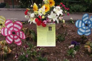 A memorial for teacher Susan Champion has been placed in the flower beds outside the entrance to Hathaway Elementary School.