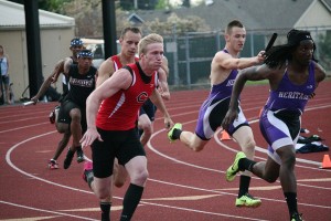 Ryan Gunther gives the baton to Cole Zarcone during the district 400-meter relay race Wednesday, at McKenzie Stadium. Camas settled for second place to Heritage in the event, but broke the school record with a time of 42.99 seconds.