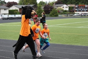 The Washougal High School Panther mascot encourages youngsters as they cross the finish line during Saturday's 10th annual Student Stride for Education at Fishback Stadium. Hundreds of youth and adults took part in the running and walking events, which serve to promote fitness and learning and fundraise for the Washougal Schools Foundation's grant and scholarship program