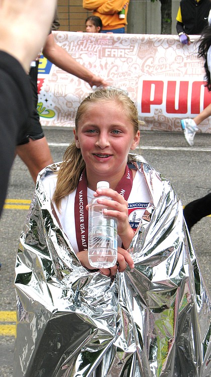 Contributed photo
Lattimer grins after finishing the Vancouver U.S.A. half-marathon last year. She set the course record for runners 15 and younger as a seventh-grader.