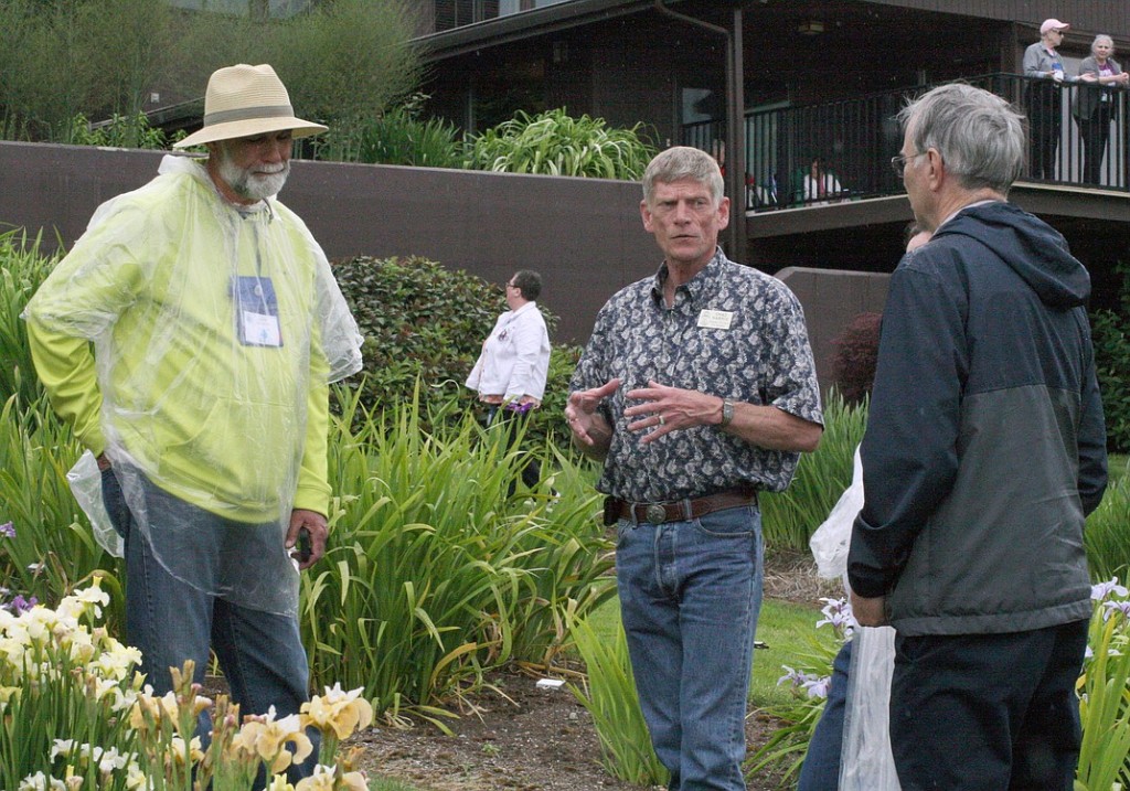 Chad Harris, center, discusses various characteristics of his irises with other members of the American Iris Society.