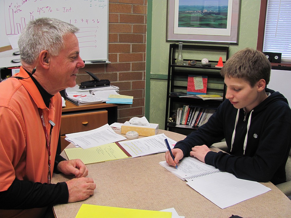 Ron Carlson is retiring after 40 years in education. He has served as principal of Jemtegaard Middle School in Washougal for the last four years. Here, he visits with seventh-grader Tucker Meyer.