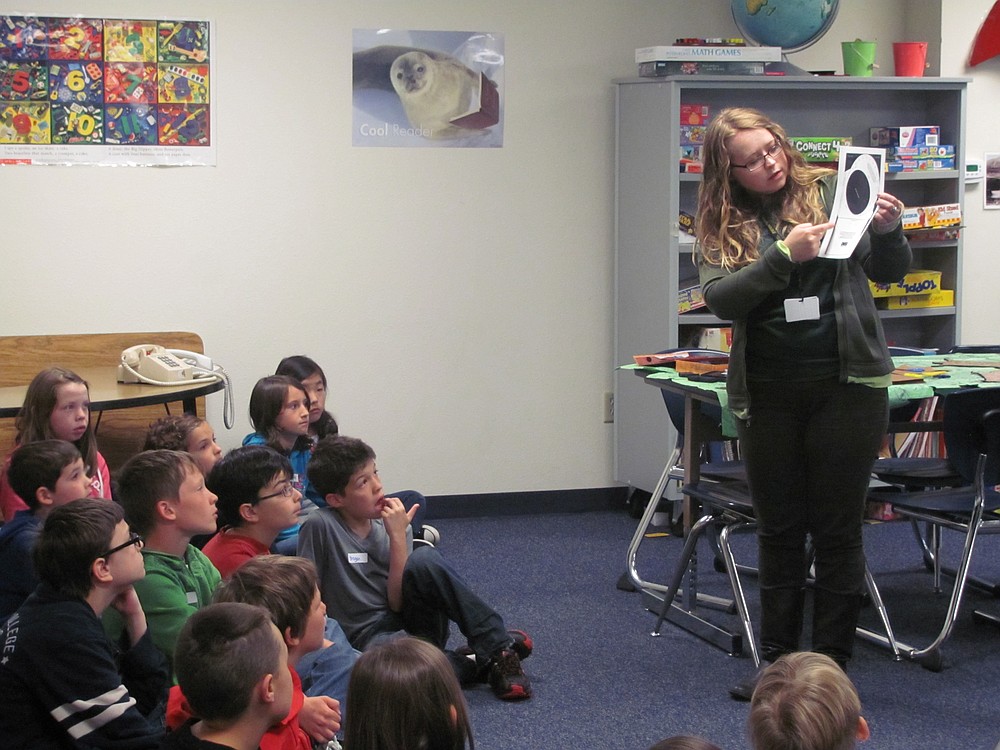 Jaimie Thompson shows fourth-graders how to make a "star finder."