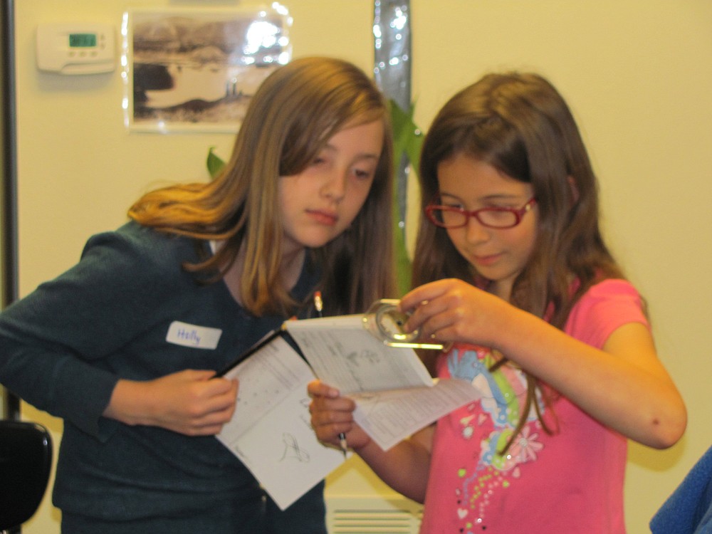 These fourth-graders try to get their bearings using a compass. Cartography was one of the interactive stations.
