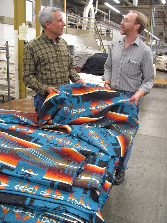 Charlie Bishop, left, vice president of mill operations at Pendleton Woolen Mill in Washougal, talks with Ted Prince, finishing supervisor. Prince has worked at the mill for 26 years. Pendleton has been named the Camas-Washougal Chamber of Commerce Business of the Year.