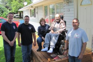 Several local fire officials recently coordinated the donation and installation of a ramp for Bob Dawson (second from right), who was diagnosed with ALS in 2013. Recently appearing with him were Jordan Boldt, Jake Grindy, Dawson's wife Charlie, and Joe Scheer. Charlie has served as a Washougal volunteer firefighter for more than 23 years. "They shocked us," Charlie said, regarding the addition of a ramp. "It was really nice."