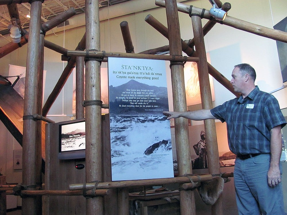 Columbia Gorge Interpretive Center Museum Director Robert Peterson said the building is designed with different elements that represent the area. Here, he stands underneath a "pithouse," replica. Inscribed is a quote from Victoria Howard, of the Clackamas Chinook.
