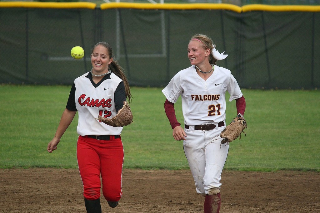 Tori O'Neill (Camas) and Jamie Phares (Prairie) run off the field together after O'Niell snagged a line drive in left for the third out.