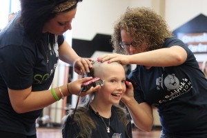 Washougal third-grader and cancer survivor Sammy Mederos reacts to getting her long locks of curly hair shaved off during a fundraiser for St. Baldrick's Foundation this afternoon at Washougal High School. Mederos was diagnosed with leukemia when she was in kindergarten. Mederos and her family helped organize the event, which included participation by Washougal Mayor Sean Guard and Cape Horn-Skye Elementary School secretary Mary La France--a breast cancer survivor. Look for a story and additional photos in Tuesday's print edition of the Post-Record.