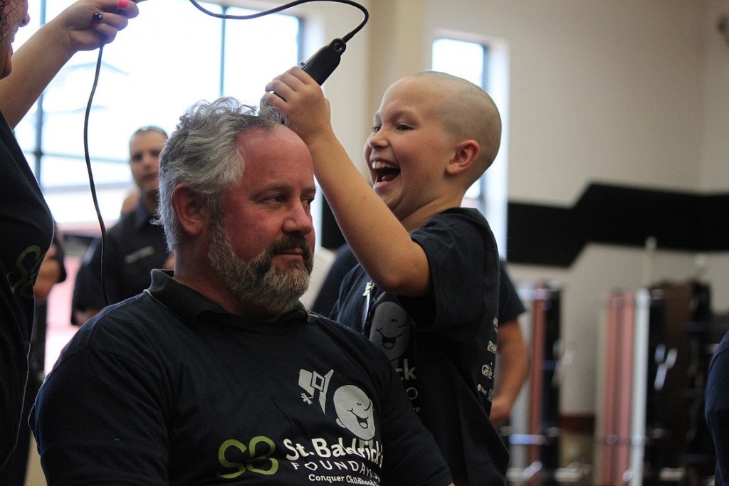 Washougal Mayor Sean Guard takes it all in stride as Sammy Mederos gets a kick out of shaving the hair off of his head on Sunday afternoon. Guard also consented to having his beard shaved off, after a donor agreed to contribute $500 to the St. Baldrick's Foundation.  "To be able to do this with Sammy, this is cool," he said. Look for additional photos from the event at www.camaspostrecord.com.