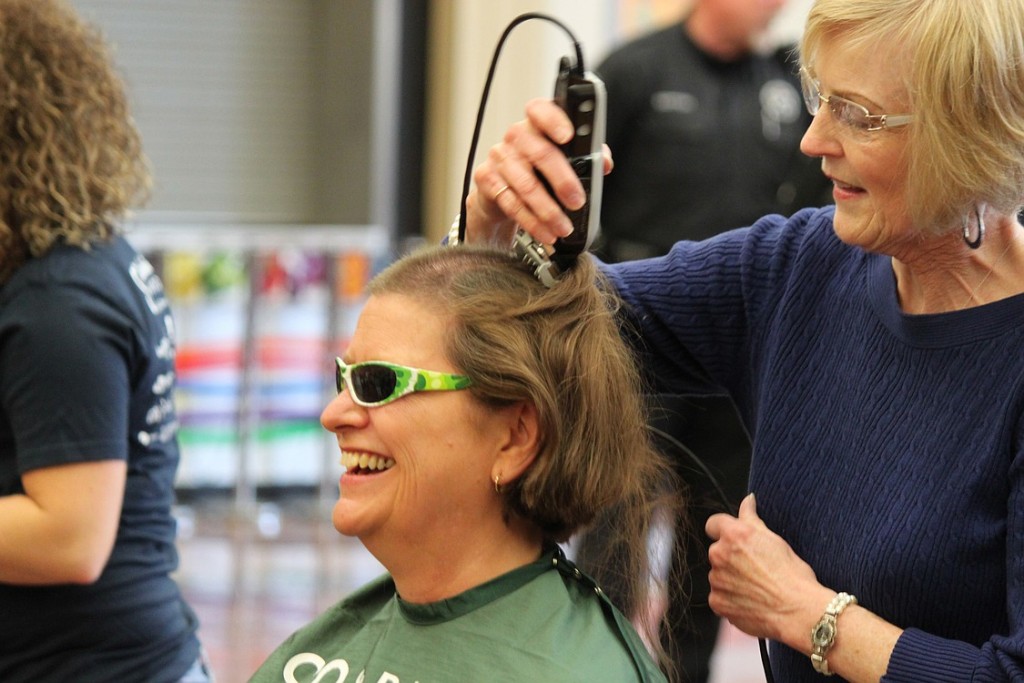 Breast cancer survivor Mary LaFrance has her head shaved by friend Kay Ritter during Sunday's St. Baldrick's fundraiser. It was a poignant moment for both women. Ritter also shaved LaFrance's head when she was losing her hair due to chemotherapy treatments eight years ago.