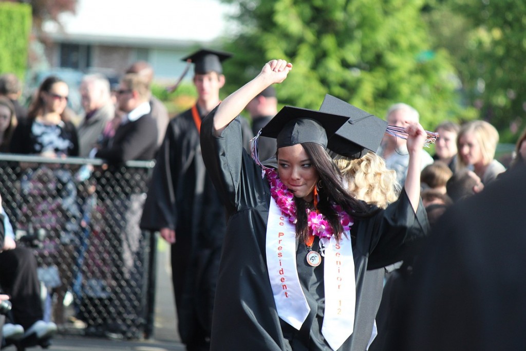 Senior class vice president Kim Yano gets into the spirit of the occasion as she makes her way into Fishback Stadium Saturday night.