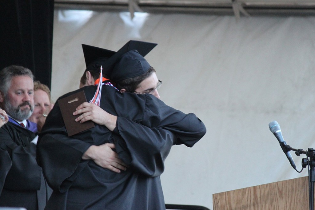 Hunter Nelson embraces his friend Danny Riat. Nelson presented Riat with a Bootstrap Award, which is given to individuals who have overcome obstacles during their high school careers. Riat survived severe injuries, including a broken back and broken ankle, following a hiking accident in July 2011.