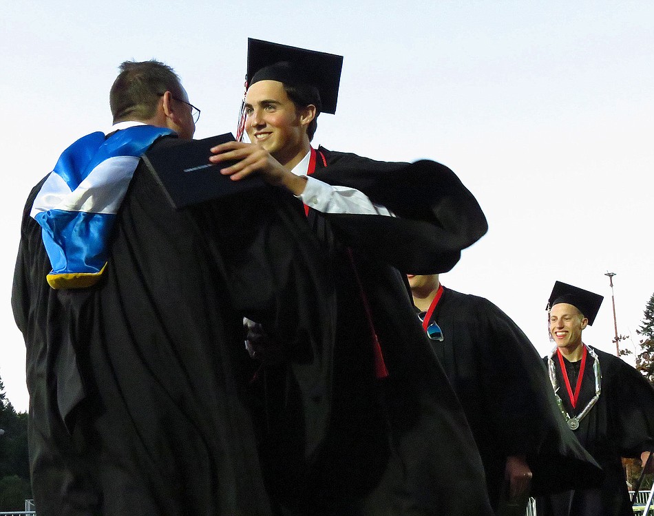 Camas High School graduates Daniel Osterhage and Taryk Boyd thank their mentors Friday, at Doc Harris Stadium.