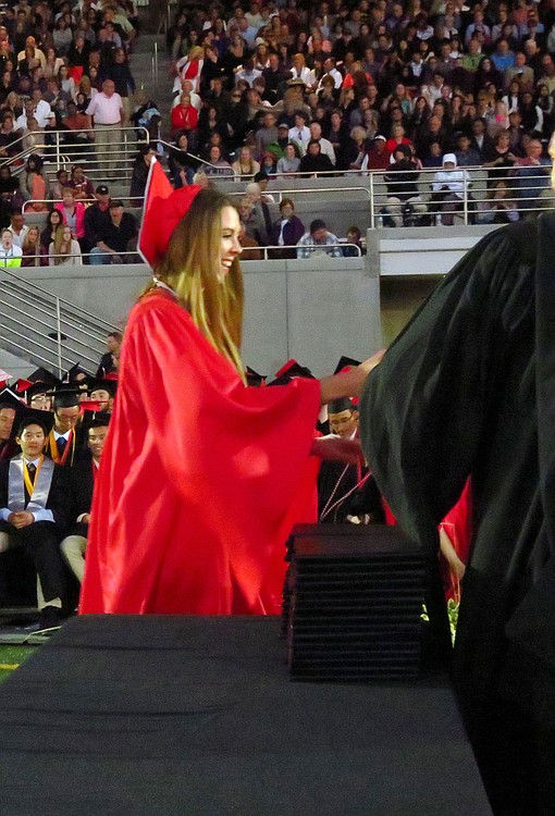 Alissa Pudlitzke receives her Camas High School diploma Friday, at Doc Harris Stadium.
