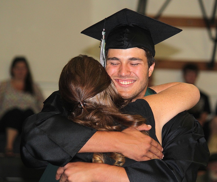 Hayes Freedom High School student Zach Hausinger hugs Principal Amy Holmes after receiving his diploma Saturday. During her speech to the crowd, Holmes described herself as passionate about the students' education. "I was fierce, you might have misjudged that as mean, about helping you make the choices that would not only get you here today, but I was fierce because you deserved to get here with incredible learning experiences, amazing memories and most importantly hope," she said. "You are smart, talented, strong-willed and powerful beyond measure."