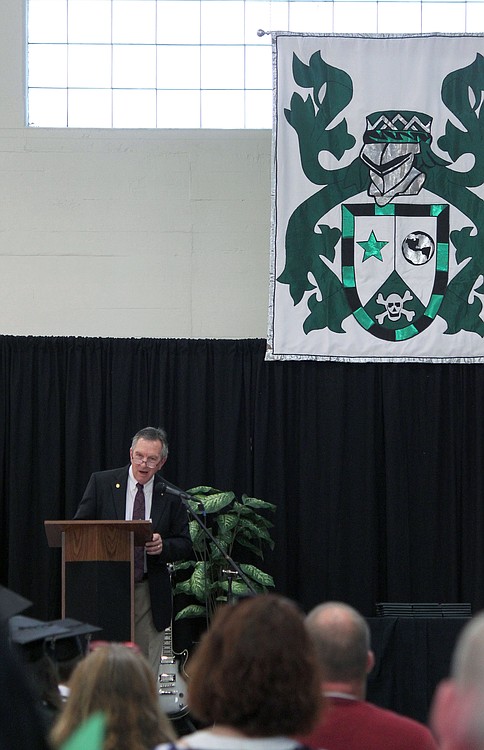 With the Hayes Freedom High School crest in the background, teacher Mike Brasch delivers his speech Saturday afternoon. Brasch, the 2014 Camas-Washougal Chamber of Commerce Teacher of the Year, spoke to the students about making the right choices. "Own your mistakes, accept responsibility, don't blame others and have a plan," he said. "You can't see into the future, but you can make plans that help you to be in the right places, at the right time, with the right people."