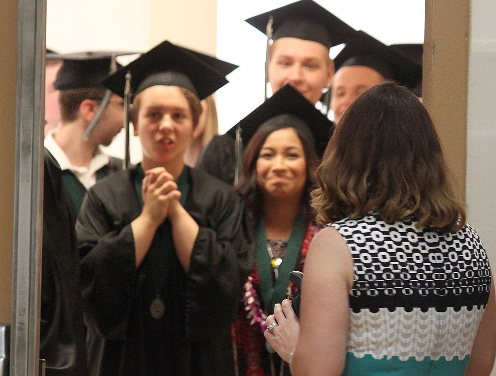 Teacher Monica Winkley chats with students Phoebe Jud,  Daniela Garcia and Bryson Dobson as they wait to begin Hayes Freedom High School graduation ceremonies Saturday.