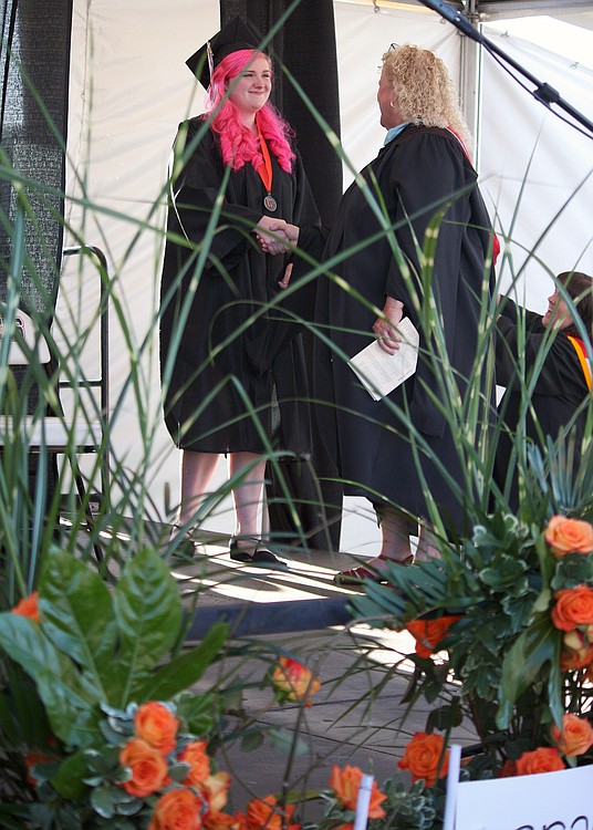 WHS Associate Principal Carol Boyden greeted graduates on stage before they received their diploma cases. They picked up their actual diplomas on Monday.