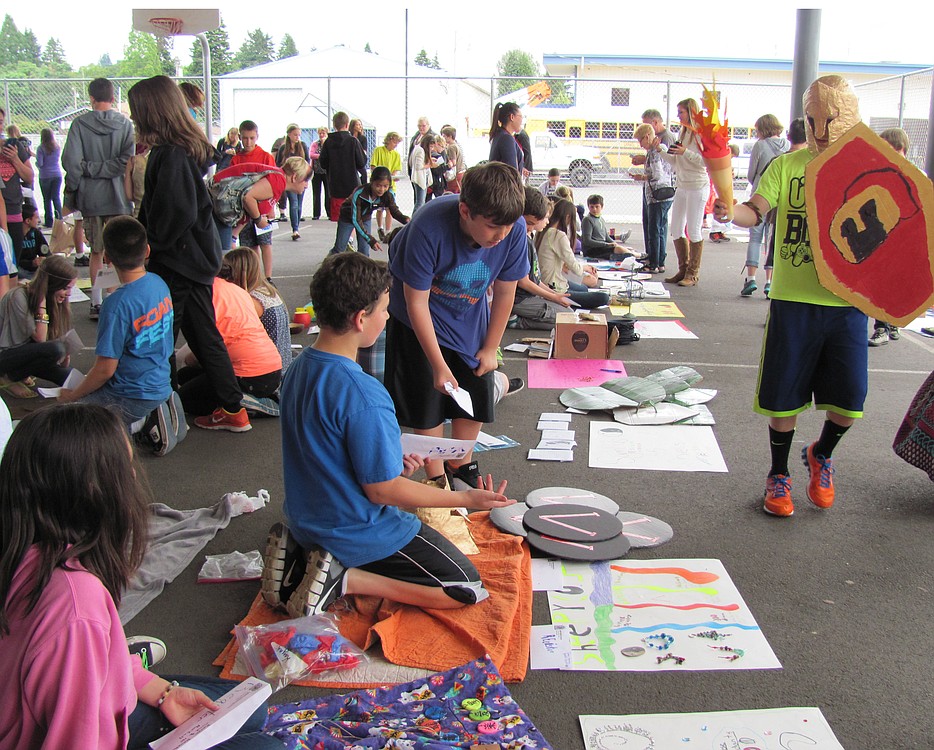 Students sell and buy items during Ancient Market Day, a lively event at Liberty Middle School. The purpose is to give them a hands-on experience in trade and economics.