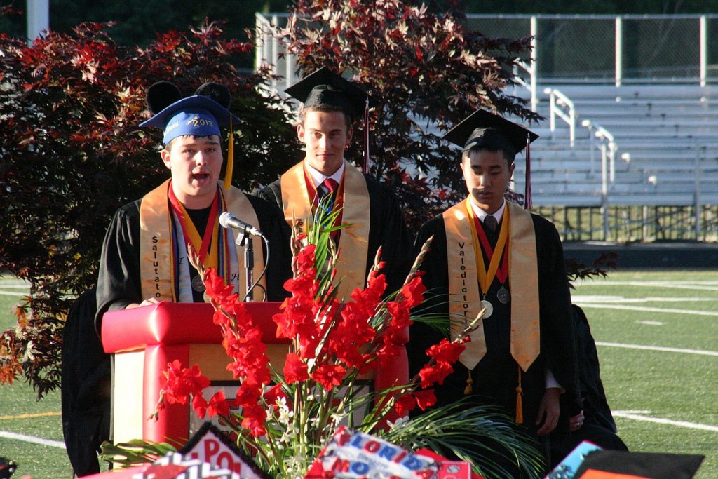 From left, CHS salutatorions Triton Pitassi and Nicholas Napier, and valedictorian Jake Hsu give short but sweet speeches at commencement ceremonies Friday at Doc Harris Stadium.