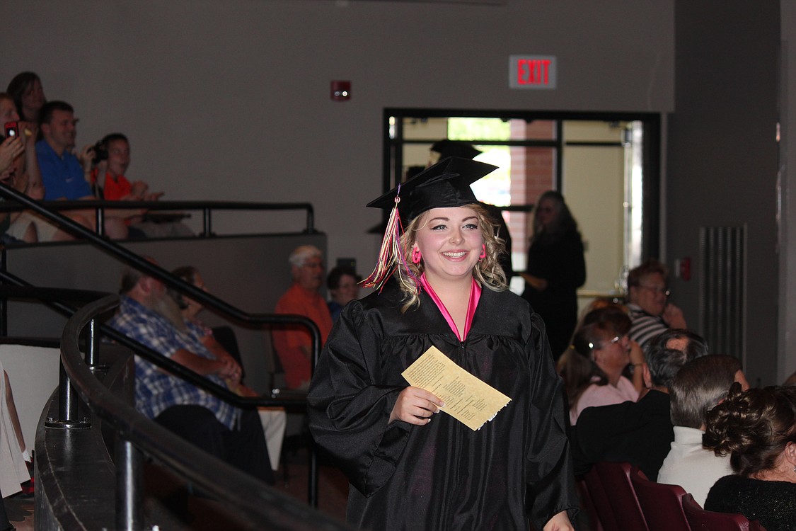 Mariah Rollins makes her way into the theater during the processional of seniors during the Excelsior graduation on Friday.