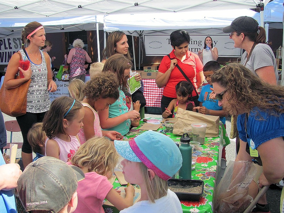 The Kid's Connection booth was packed with children making "flower bombs." They learned how seeds germinate and why it is important to attract butterflies to a garden.