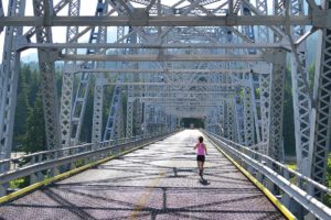 The Bridge of the Gods Half Marathon and 10K races begin with a breathtaking sprint across the Columbia River from Washington into Oregon. The bridge stretches 1,858 feet across and stands 140 above the river. The grated road allows runners and walkers to see the rushing water below their feet.