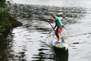 Erick Gelbke curls around the shore at Lacamas Lake. The Sweetwood Paddleboard guide, from Whitefish, Mont., loves tooling around the water with beginners and experienced riders. "I always enjoy the stoke people have," Gelbke said.