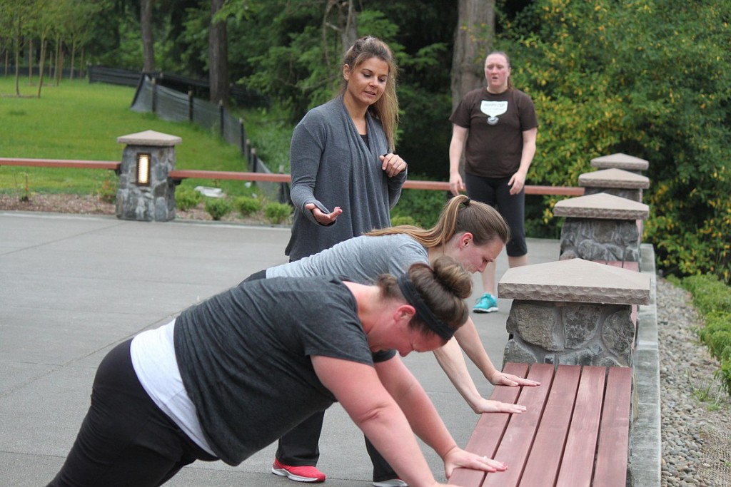 Certified personal trainer Anna Stephens provides instruction to Lindsy Palisca, Stephanie Lowery and Krissy Barlow, as part of the metabolic conditioning class offered through Camas Parks and Recreation. Stephens said she aims to provide a workout that is varied and fun. Held at Lacamas Lake Lodge, she often takes the class outside, when weather permits. "I like to change it up so people don't get bored," Stephens said.