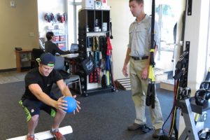 Guy LaRue builds strength and flexibility with physical therapist Steve McCarthy at Washougal Sport & Spine. LaRue broke his back in a quad riding accident in 2010. McCarthy is helping him make a full recovery.