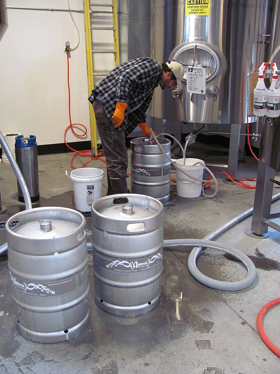 Chris Spollen, a brewer with Amnesia Brewing, kegs some Kill Switch IPA from one of the conditioning tanks in downtown Washougal. The 5,500-square-foot site is expected to produce up to 6,000 barrels of beer this year.