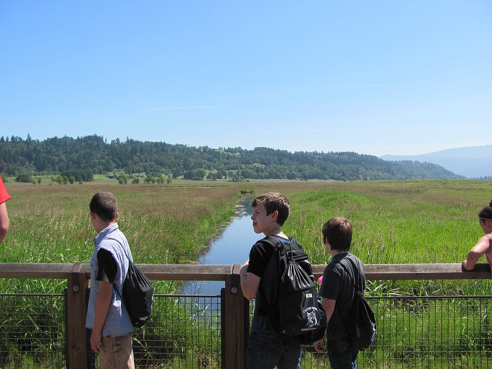 Students pause to look for birds during a hike at the Gibbons Creek Wildlife Art Trail. It is part of the 1,049 acre Steigerwald Lake National Wildlife Refuge.