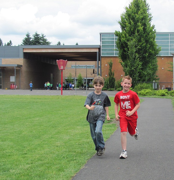 Shayne Swanberg (right) and Lukas Scharrelman were the top runners at Helen Baller Elementary School after they logged 105 and 120 miles, respectively, on the school track during a  running club competition.