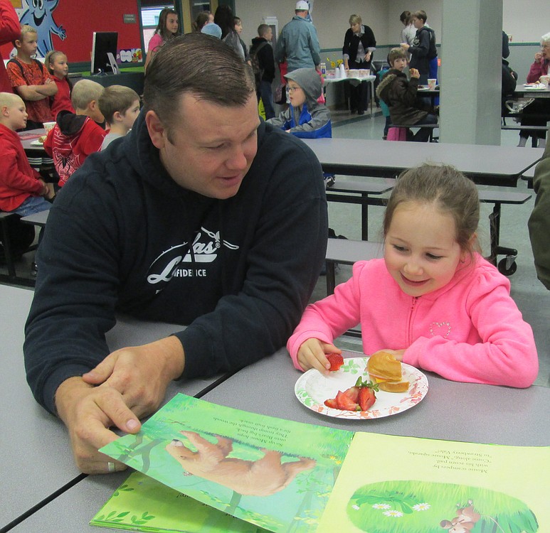 Seth Teeters and his daughter, Lela, enjoy the Books and Breakfast event at Cape Horn-Skye Elementary. It gives students and their parents a chance to read and eat together, and is one of the unique programs at the school.