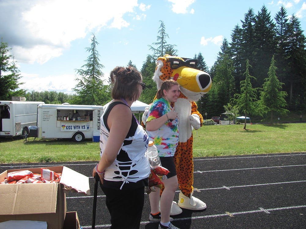 Peggy Denny, 19, poses with "Chester Cheeta," who was handing out free Cheetos to participants. It's her first year on a relay team.