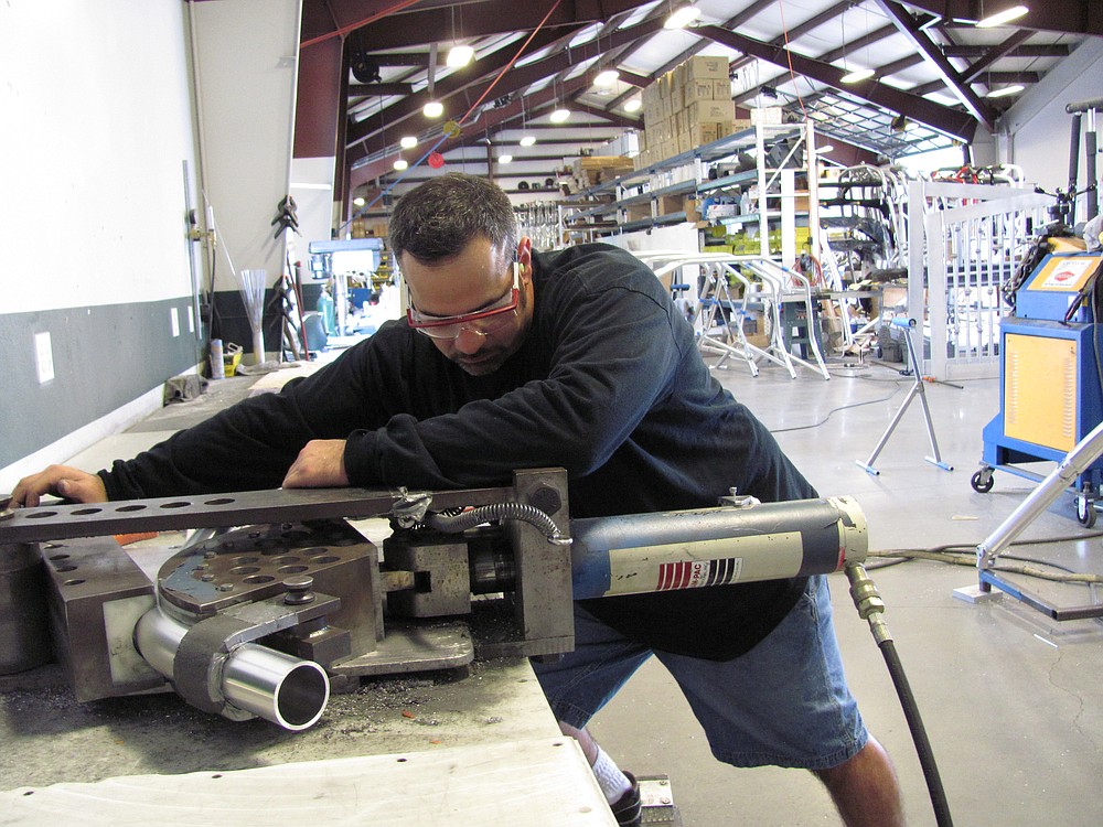 Bill Walters, a fabricator at Samson Sports, cuts, bends and shapes metal to make custom wakeboard towers. The 11-year-old company also makes fishing towers and racks to hold waterskis, speakers and lights.