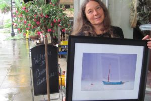 Kirsten Muskat founded the Camas Camera Club three years ago. She and several other members are exhibiting their work at the Second Story Gallery this month.  Here, she holds her photograph, "If" that will be included in the show.