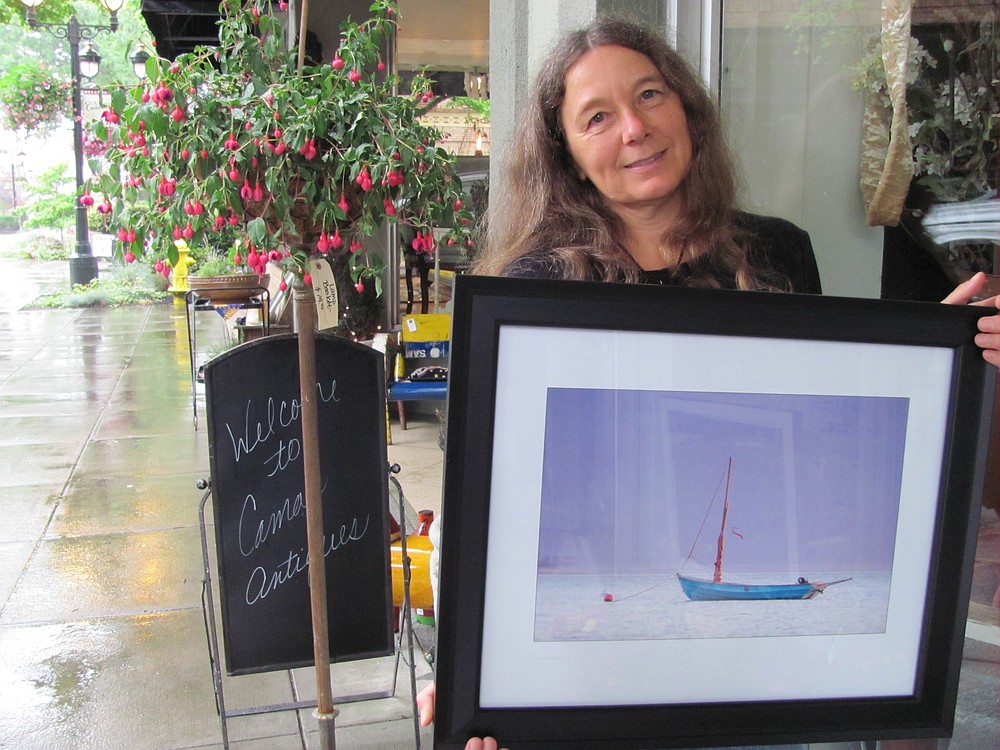 Kirsten Muskat founded the Camas Camera Club three years ago. She and several other members are exhibiting their work at the Second Story Gallery this month.  Here, she holds her photograph, "If" that will be included in the show.