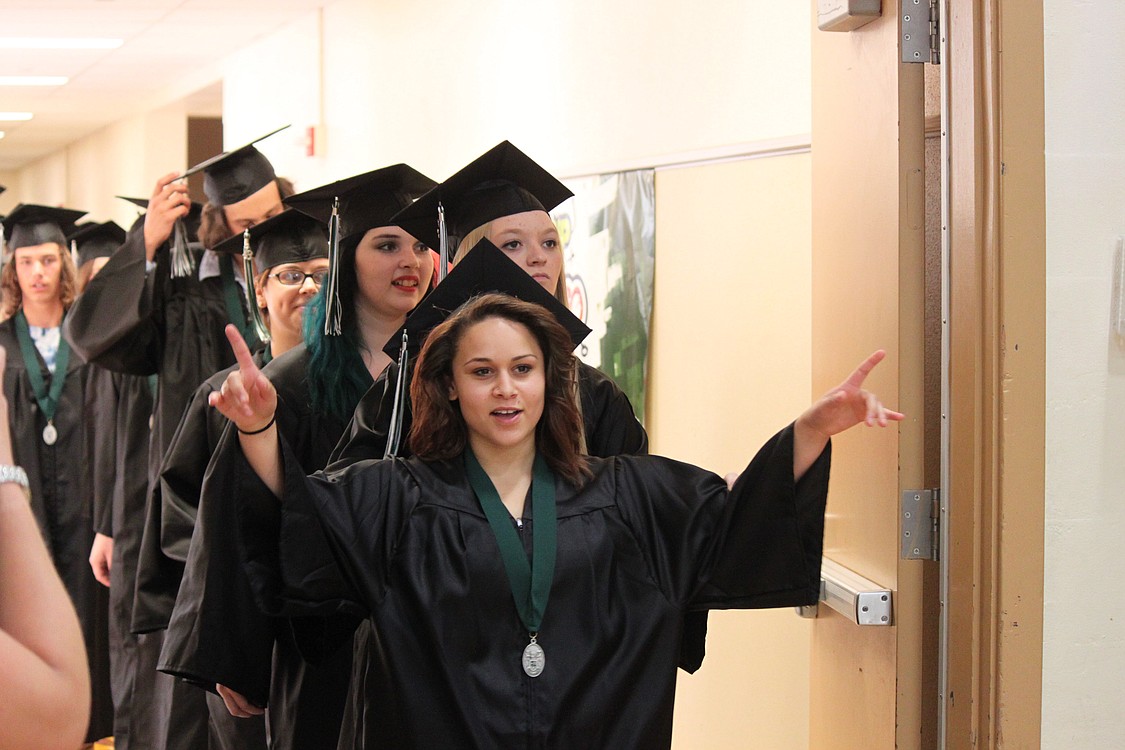 Crystal Garcia leads a line of seniors as they walk into the gymnasium, where they will become graduates of Hayes Freedom High School. The Camas School District's alternative school had 40 graduates during ceremonies at Liberty Middle School on Saturday.
