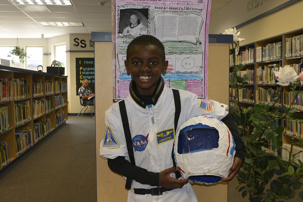 Gabe Lowery dressed up as astronaut Neil Armstrong for his presentation. Students stood like statues around the Gause Elementary School library. When someone touched the "magic" red dot on the back of their hand, the students came to life as that person.