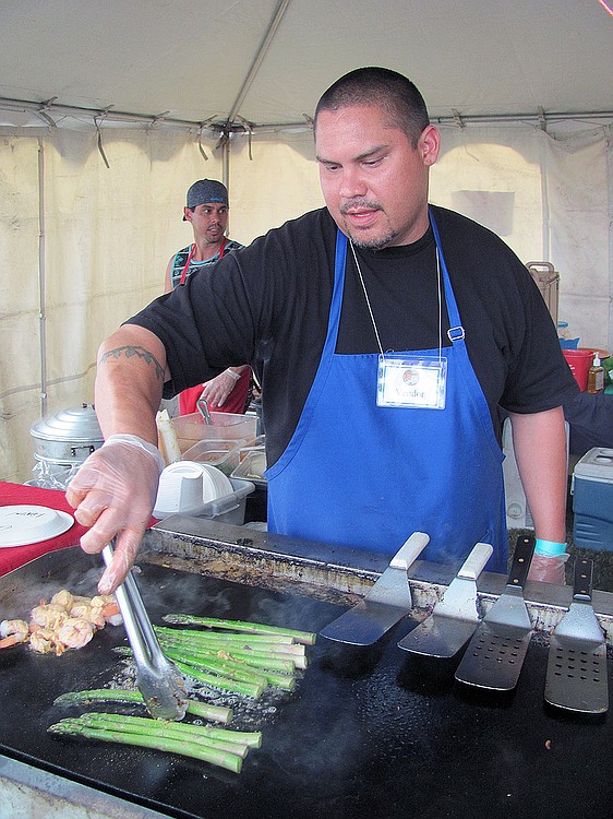 Steve Lacio, a chef at Canby Asparagus Farm, of Milwaukie, Ore., cooked shrimp and asparagus on a grill. Other food vendors served alligator sausage, taco salad and barbecue ribs.