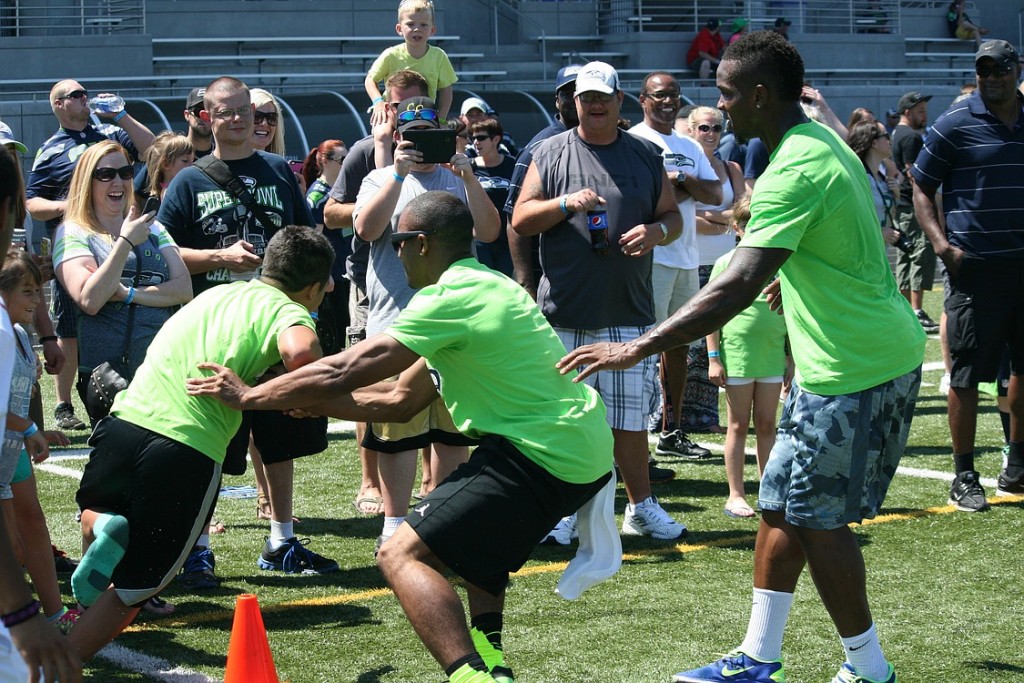 A lost shoe doesn't stop this kid from running by Seattle Seahawks Doug Baldwin and Phillip Bates to catch a pass. The Play 60 Family Fest provided a variety of games, challenges and activities for people of all ages to try at Doc Harris Stadium.