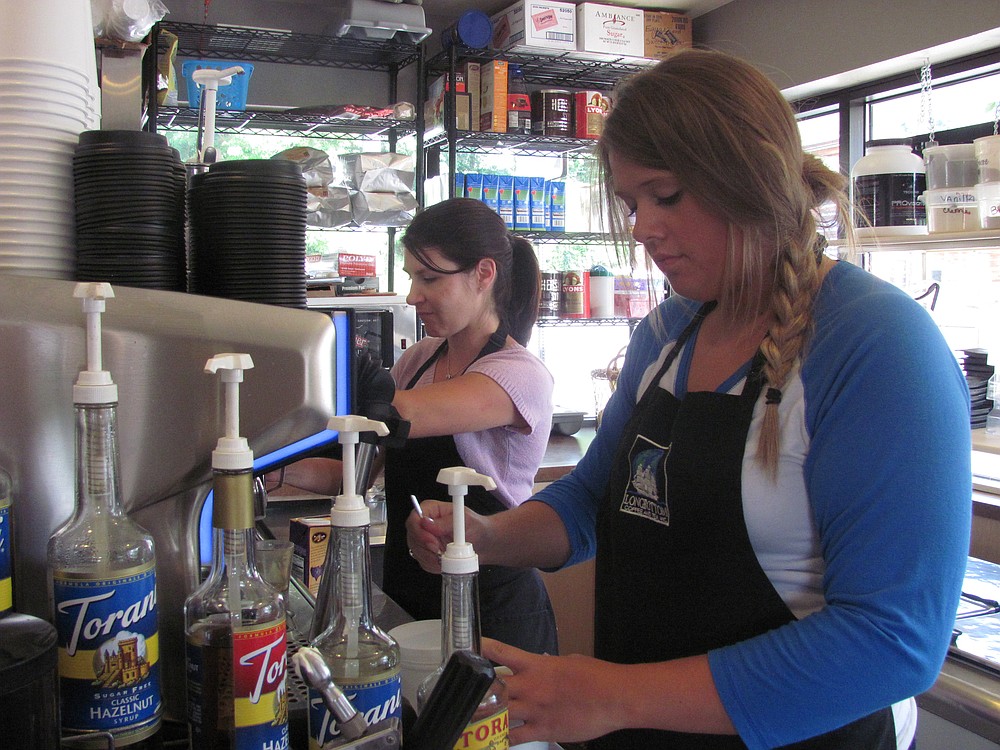 Barista Danni Southard prepares a drink at Squeeze & Grind. She works approximately 32 hours a week during the summer, and around 20 during the school year.